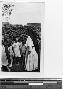 A Maryknoll Sister with children at orphanage at Luoding, China, 1935
