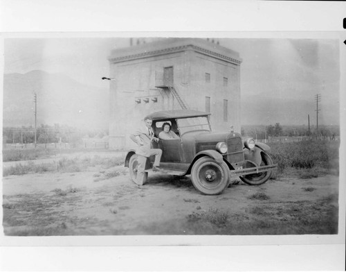 Mr. and Mrs. La Violette in an automobile in front of the City of Los Angeles Sylmar Substation