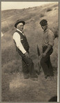 [Alfred Fuhrman standing in field next to man with visor]