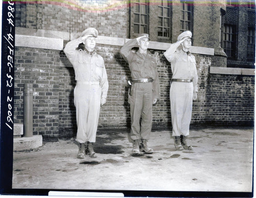 Generals Collins, Van Fleet, and Clark saluting the flag during inspection tour of Korean front