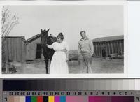 Emma Phillips and Harold Thorsen with horse on Phillips Ranch