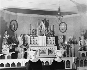 Two nuns of the Daughters of Charity pray to a shrine of Jesus Christ, 1950