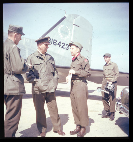 General Van Fleet with officers in front of transport plane