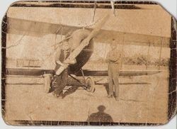 Sam Huck and his biplane at Cnopius Field, Sebastopol, with Rudolph Rodriguez of Metcalf Hardware holding propeller, 1920s