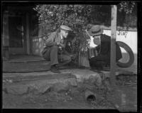 Two men on the porch of a house after a catastrophic flood and mudslide, Montrose and La Crescenta, 1934