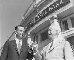 Two men in front of the Petaluma, California office of the first National Bank, 1958