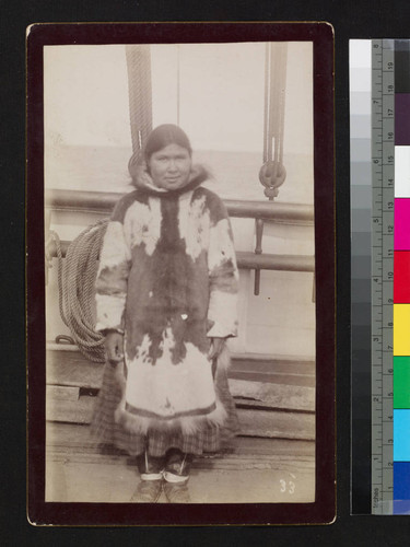 Alaska native woman on ship deck with fur coat