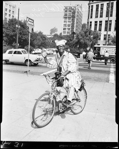 Bicyclist arrives at City Hall, 1952