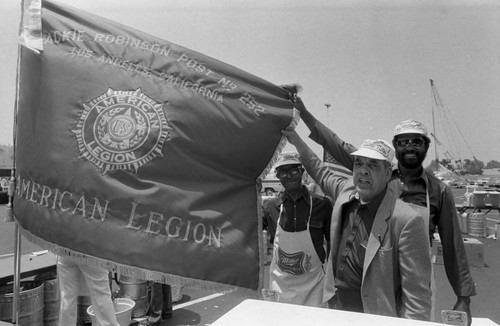 Crenshaw Festival participants from the American Legion displaying their flag, Los Angeles, 1983