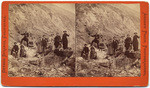 [Group of men and women standing on rocks]