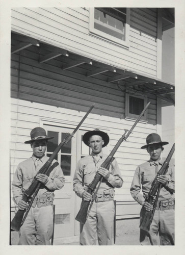Three soldiers holding rifles