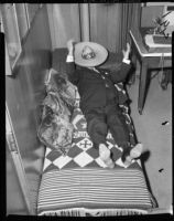 Los Angeles County sheriff Eugene Biscailuz resting under sombrero, 1958