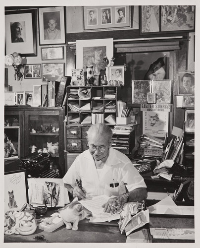 Guy Bogart in 1955, sitting and working at his desk at 545 Euclid Ave