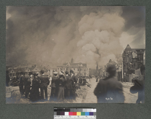 [Crowd watching fire. From Alamo Square? Dome of City Hall in distance.]