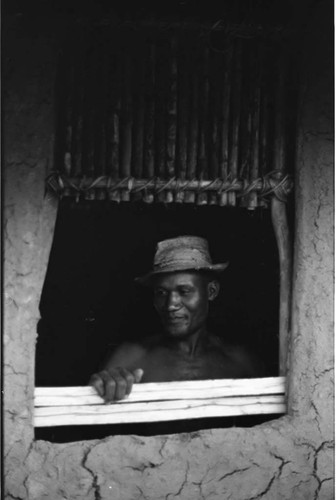 Man with a hat works on a window, San Basilio de Palenque, 1975