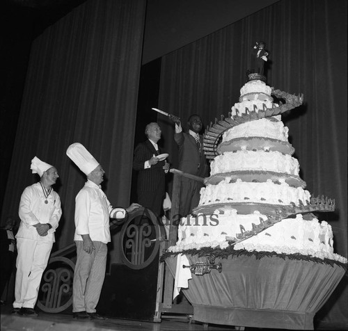 Louis Armstrong cutting the cake celebrating his 70th birthday, Los Angeles, 1970