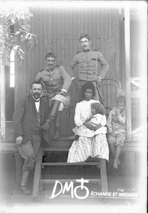 Group of people in front of a building, Mozambique, ca. 1896-1911