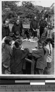 Little girls reading at Tai Wan mission in Wuchow, China, 1935