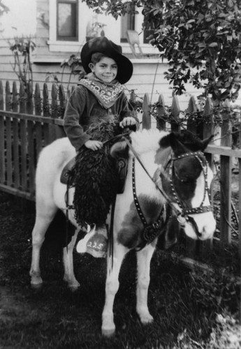 Mexican American boy on pony