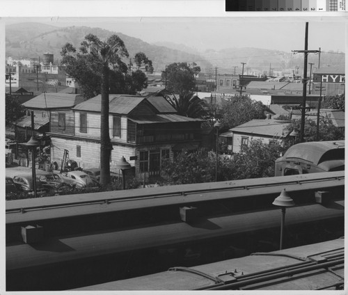 Photograph of Los Angeles slum houses located directly across from railroad tracks