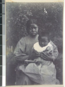 Mariavelo, a Malagasy woman with a child on her lap, Antananarivo, Madagascar, ca.1905
