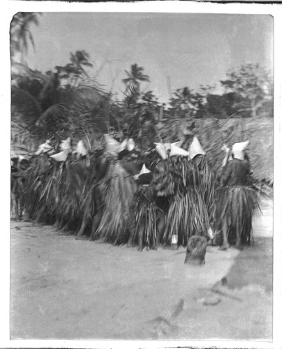 Santa Catalina dancers dressed with leaf skirts and conical hats