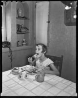 An unidentified girl enjoys a meal, Los Angeles, 1936