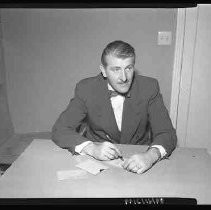 An unidentified man seated at a desk