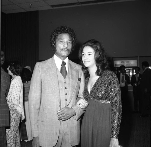 Ken Orduna poses with a woman at an event for Tom Bradley, Los Angeles, 1974