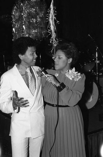 John Quarry and Lillian Miller singing during the James and Odessa Bohana 50th wedding anniversary celebration, Los Angeles, 1984