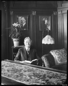 Edward Doheny with book, office, Doheny Mansion, Los Angeles, Calif., ca. 1931-1932