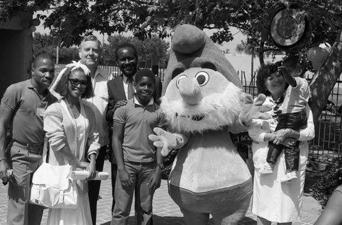Black Audition Festival participants posing with a Smurf, Los Angeles, 1985