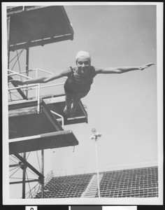Female diver jumping off a diving board, ca.1930