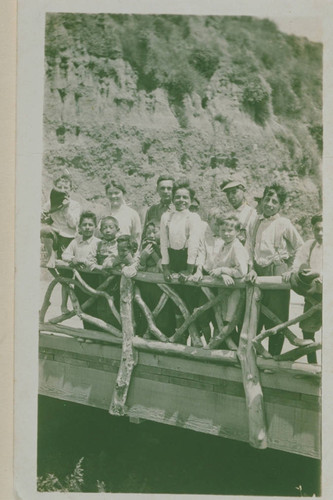 Marquez family and other children of Canyon School gathered on a bridge above Santa Monica Creek