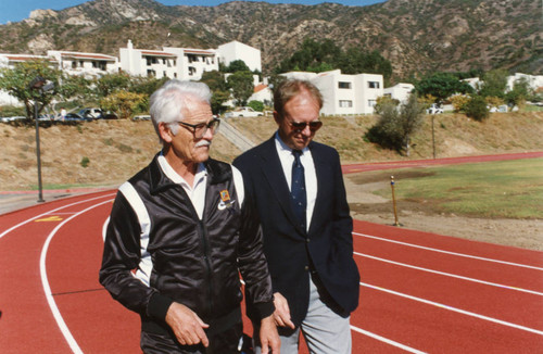 Mr. Stotsenberg walking with a man on the Track