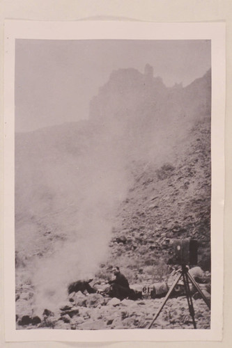 Charles Russell sits by the campfire in Cataract Canyon