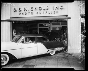Car in window of camera shop, 1959