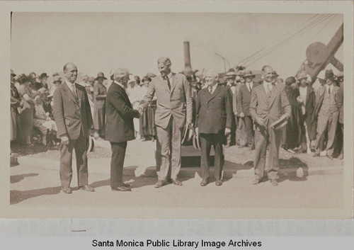 Men greeting one another at opening ceremony of Beverly (later Sunset) Blvd. including Dr. Charles Scott, President of the Pacific Palisades Association (far left), August 18, 1925