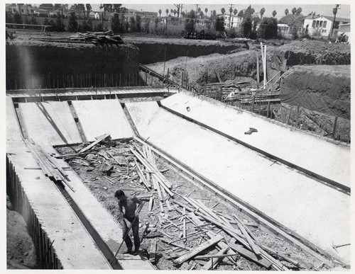 Construction of the Santa Monica Municipal Pool showing pool footing while stripping forms with pipe chase, August 16, 1950