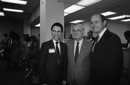 Paul C. Hudson posing with two unidentified men during an event at Broadway Federal Savings and Loan, Los Angeles, 1984