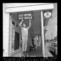Postmaster William A. Cook hanging sign designating building as East Irvine post office, Irvine, Calif., 1965