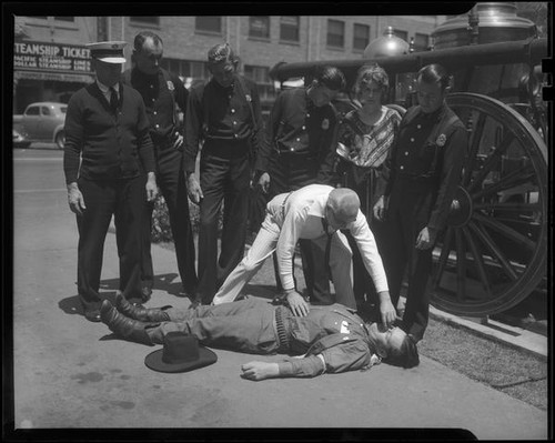 Dr. St. Louis Albert Estes demonstrating a rescue maneuver for uniformed men, between 1933 and 1936