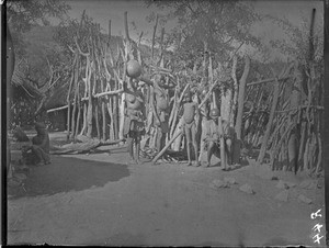 African people in front of a village, Mhinga, South Africa, ca. 1892-1901