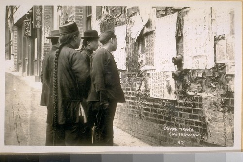The Dead Walls of China Town at the N.W. cor. Washington & Dupont St. in 1900 - see the ques [sic] on the men. China Town - San Francisco