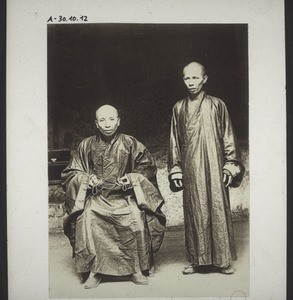 Abbot with rosary and priest of a buddhist monastery