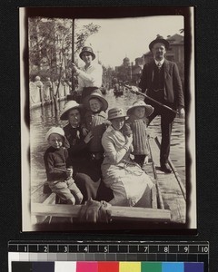 Missionaries with families travelling along flooded roads by boat, Tianjin, China, ca. 1915