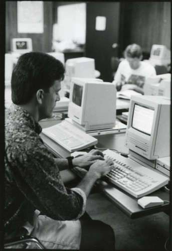 Photograph of a man student working at his computer