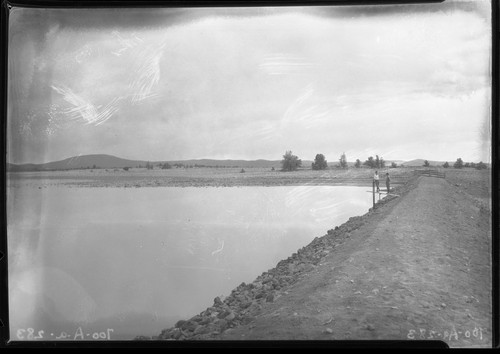 Earth-filled dam of Silver Flat Reservoir near Hayden Hill, Lassen County. Built by the Juniper Irrigation Company at a cost of about $13,500