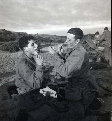 Two trainees shaving in the field at Fort Ord