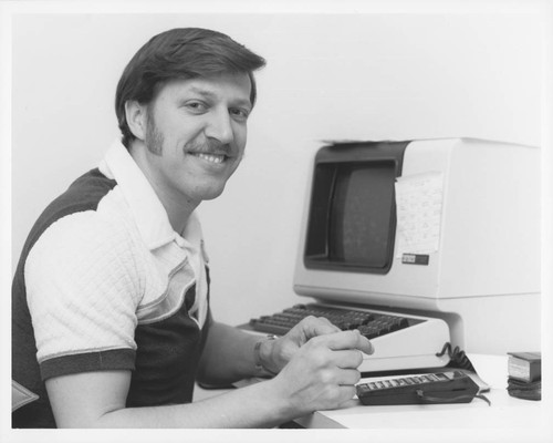 Gary Fouts, seated at a computer